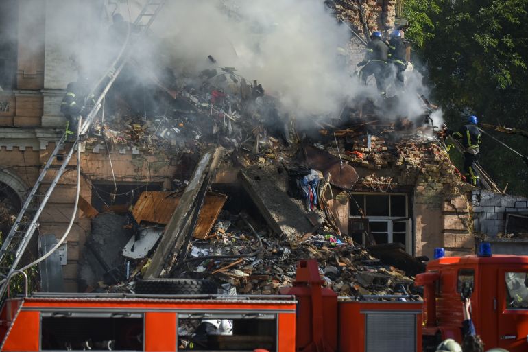 Ukrainian rescuers scour the rubble at a residential building destroyed in a Russian drone attack in downtown Kyiv