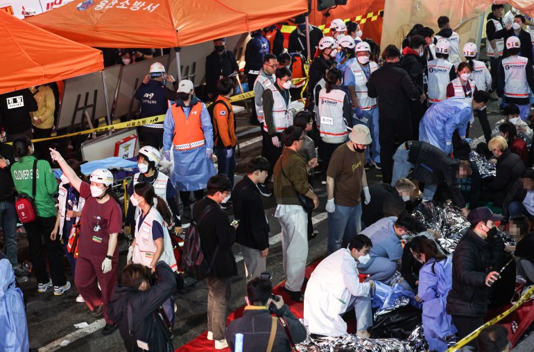  Emergency workers attend to victims of the Halloween stampede in Seoul.