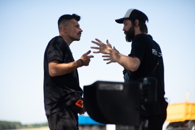 A photo of Sergej on set talking to another person.