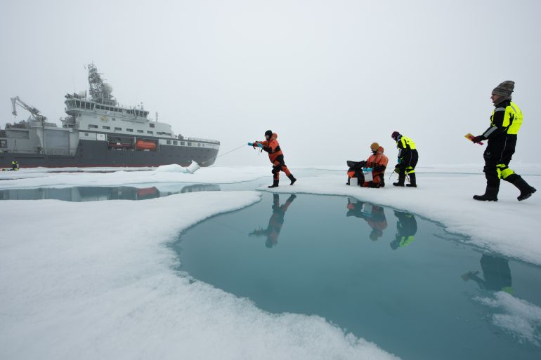 Researchers on sea ice during a research expedition to the Barents Sea, July 2021.