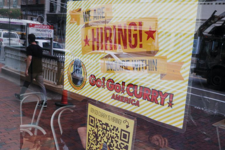 The Go! Go! Curry restaurant has a sign in the window reading "We Are Hiring" in Cambridge, Massachusetts, U.S.