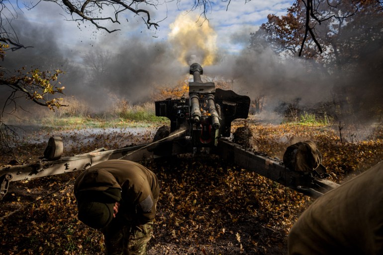 Ukrainian artillerymen fire a 152 mm towed gun-howitzer (D20) at a position on the front line