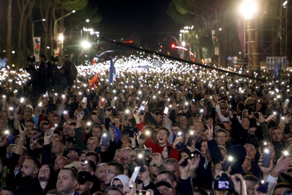 Protesters hold up flashlights from their mobile phones during an anti-government rally in front of government headquarters in Tirana, Albania.
