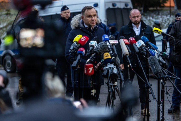 Poland's President Andrzej Duda (C) speaks during press conference on November 17,2022 in the eastern Poland village of Przewodow, where a missile strike killed two men, near the border with war-ravaged Ukraine.