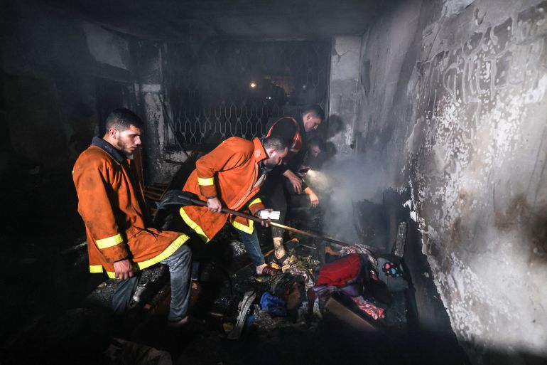 Palestinian firefighters extinguish a fire in Gaza.
