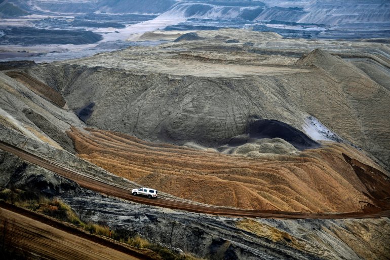 A car drives through the open-cast lignite mine of German energy giant RWE in Garzweiler, western Germany, on January 17, 2022.