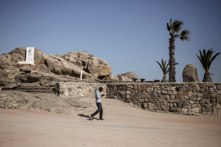 A man walks past a monument remembering those killed in the genocide in Namibia between 1904 and 1908