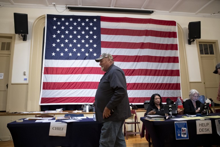 A man gets his ballot to vote on election day at a polling location at the Old Stone School in Hillsboro, Virginia.