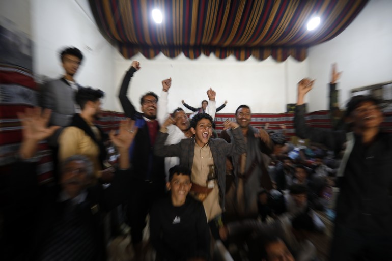 Yemeni soccer fans react as they watch a live broadcast of the FIFA World Cup Qatar 2022 group C soccer match between Argentina and Saudi Arabia, inside a paid-entry shop in Sana'a, Yemen, 22 November 2022.