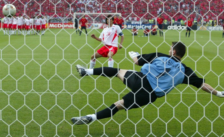 Hong Myung-bo scores the winning penalty past Spain's goalkeeper Iker Casillas
