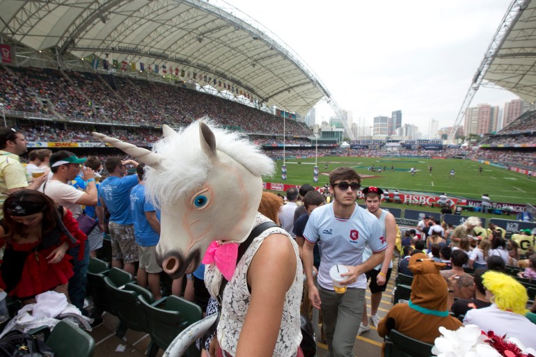A rugby fan wearing a horse head mask walks in the spectators' stand during the last day of the three-day Hong Kong Rugby Sevens tournament in 2013.
