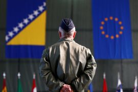 A member of European Forces (EUFOR) stands in front of the Bosnia and Herzegovina and European Union flags during Change of Command Ceremony in Sarajevo, Bosnia and Herzegovina March 28, 2017. REUTERS/Dado Ruvic