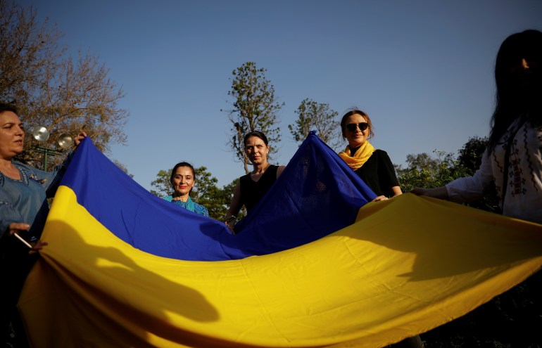 Ukrainian citizens hold their national flag in solidarity with their compatriots after Russia's invasion of Ukraine, at Lodhi Garden in New Delhi, India, April 1, 2022. REUTERS/Adnan Abidi