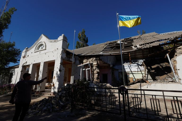 A Ukrainian national flag rises over a local council's headquarter building in the village of Lymany near a frontline in Ukraine's Mykolaiv region on October 18