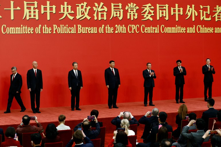 New Politburo Standing Committee members Xi Jinping, Li Qiang, Zhao Leji, Wang Huning, Cai Qi, Ding Xuexiang and Li Xi arrive to meet the media following the 20th National Congress of the Communist Party of China, at the Great Hall of the People in Beijing, China October 23, 2022.
