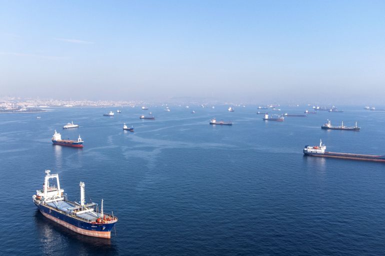 Commercial vessels including vessels which are part of Black Sea grain deal wait to pass the Bosphorus strait off the shores of Yenikapi during a misty morning in Istanbul, Turkey
