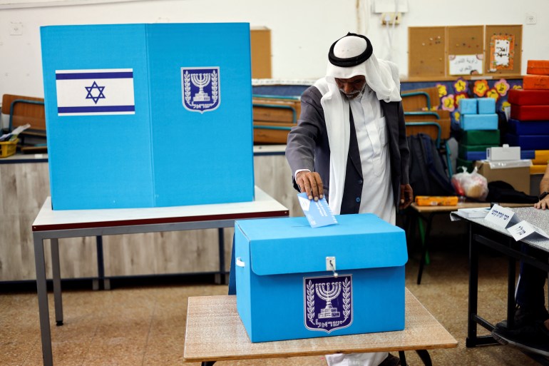 A Palestinian Israeli man casting his ballot 