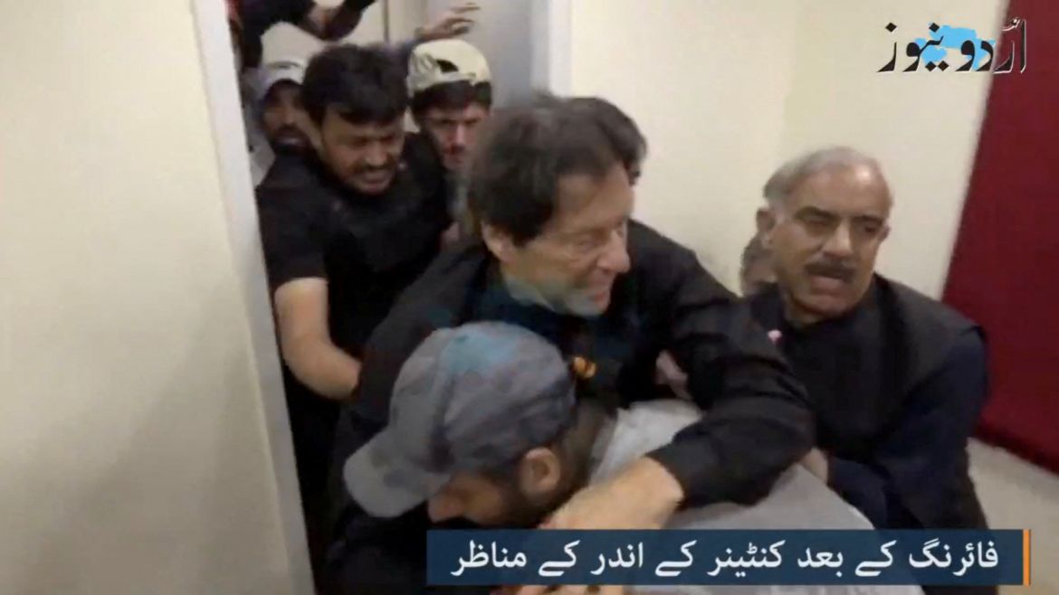 Former Pakistani Prime Minister Imran Khan is helped after he was shot in the shin