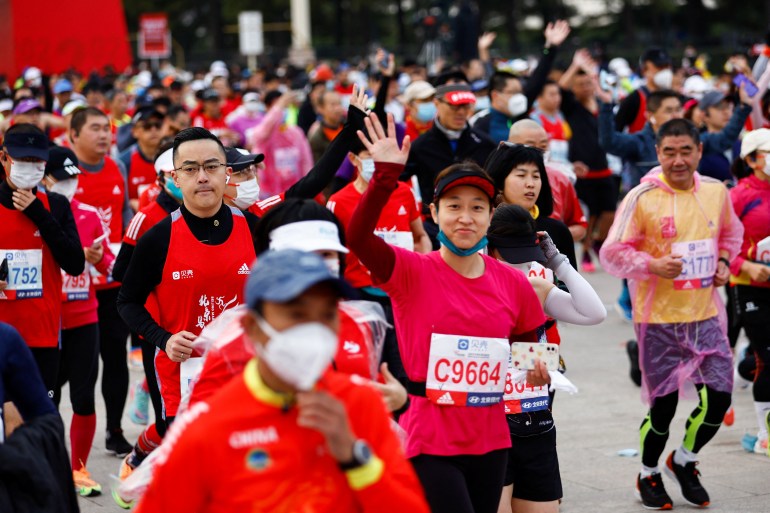 Participants wait before the Beijing Marathon