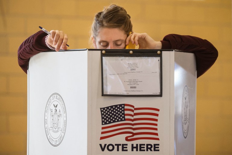 Voters fill out ballots at a polling station during voting for the 2022 midterm elections