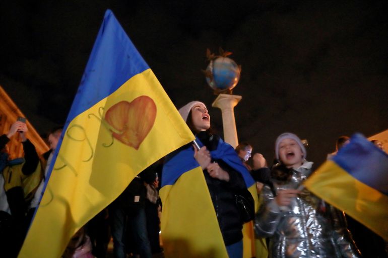 People celebrate after Russia's retreat from Kherson, in central Kyiv, Ukraine
