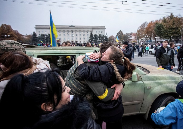 A local resident hugs Ukrainian serviceman as people celebrate after Russia's retreat from Kherson, in central Kherson, Ukraine 