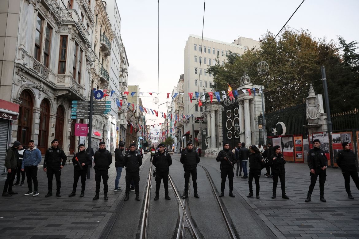 Members of the security forces stand near the scene after an explosion on busy pedestrian Istiklal street in Istanbul.