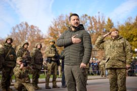 Ukraine's President Volodymyr Zelenskiy sings the national anthem during his visit in Kherson, Ukraine November 14, 2022. Ukrainian Presidential Press Service/Handout via REUTERS ATTENTION EDITORS - THIS IMAGE HAS BEEN SUPPLIED BY A THIRD PARTY.