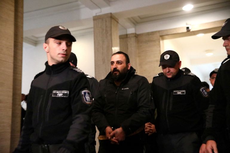 A man, charged for supporting terrorist acts in connection with an explosion in central Istanbul, is escorted to the courtroom