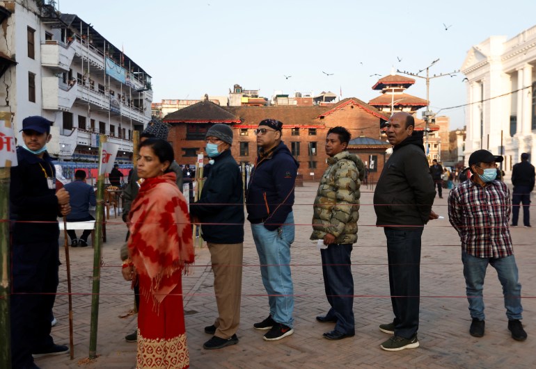 People stand in a queue to cast their votes during the general election, in Kathmandu, Nepal.