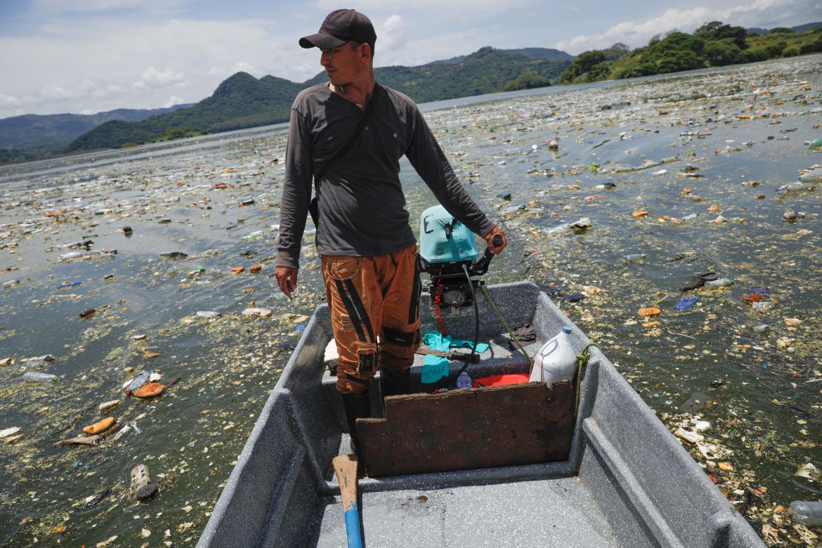 Mauricio Orellana rides his fishing boat as he cleans the