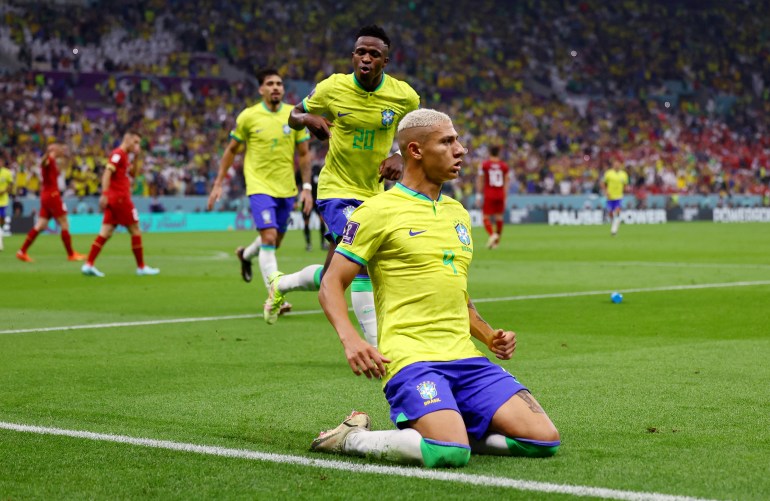 Richarlison falls to his knees in celebration after scoring a goal against Serbia