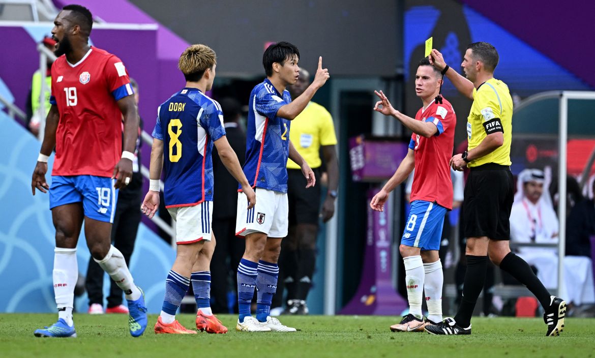 Japan's Miki Yamane is shown a yellow card by referee Michael Oliver