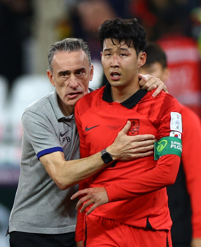 South Korea's Son Heung-min and coach Paulo Bento look dejected after losing the match.