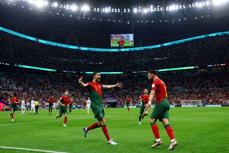 Portugal's Cristiano Ronaldo celebrates scoring their first goal with Bruno Fernandes.