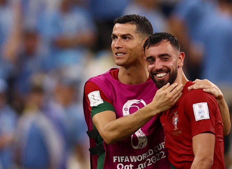 Portugal's Cristiano Ronaldo and Bruno Fernandes celebrate after beating Uruguay.