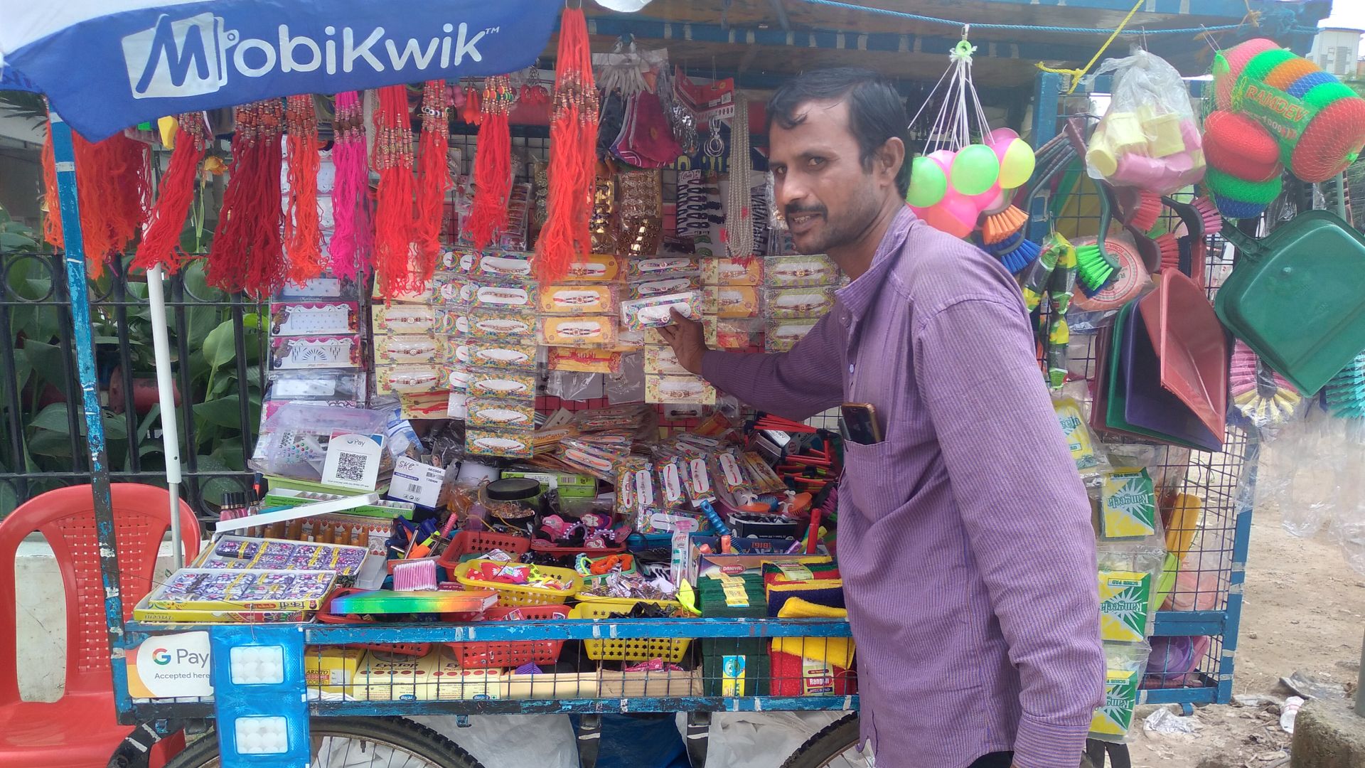 A pushcart vendor in Hyderabad, India, next to his stall