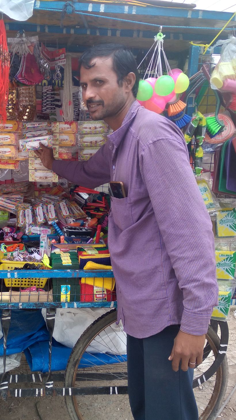 A pushcart vendor in Hyderabad, India, next to his stall