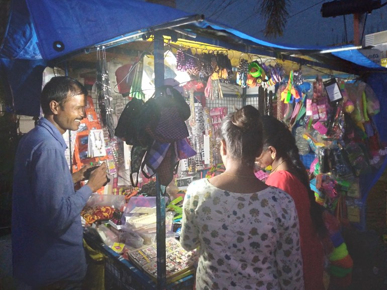 A street hawker in Hyderabad serves customers at his stall
