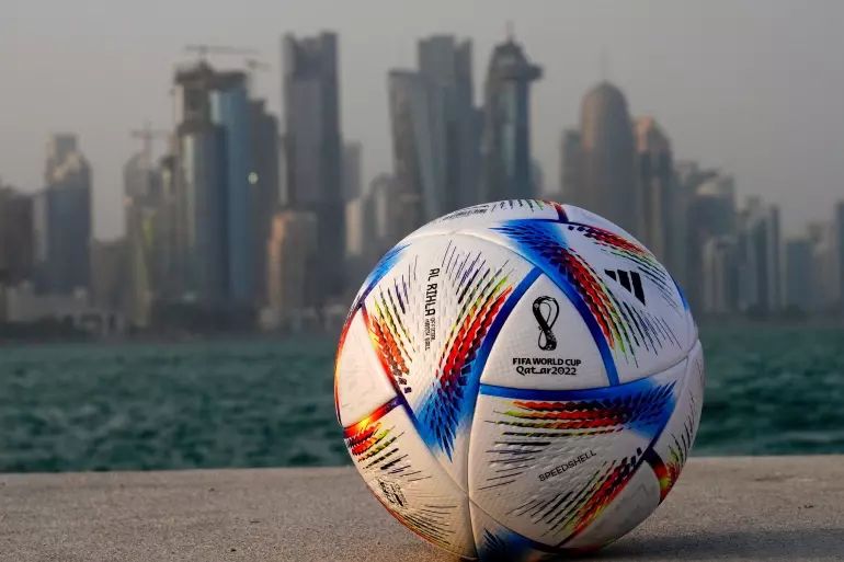 Football with Doha skyline.