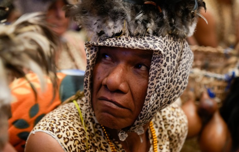 Leco Amazon Indigenous person, dressed in jaguar print, at a ceremony to preserve Madidi National Park against mining efforts