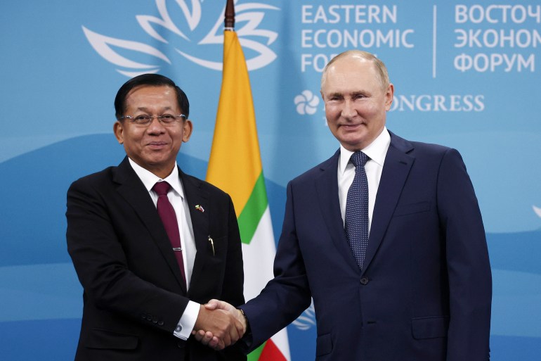 Russian President Vladimir Putin and Myanmar Senior General Min Aung Hlaing shake hands and pose for a photo during their meeting on the sideline of the Eastern Economic Forum in Vladivostok, Russia.