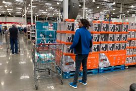 Shoppers ply the aisles of a Costco warehouse, in Sheridan, Colo.