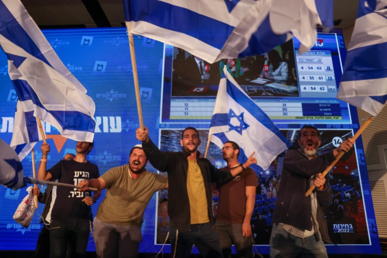 Supporters of Israeli far-right legislator and head of "Jewish Power" party, Itamar Ben-Gvir, wave Israeli flags and cheer as they celebrate his strong election performance.