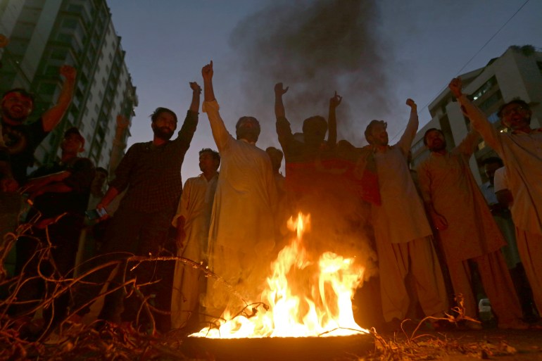 Supporters of former Pakistani Prime Minister Imran Khan, chant slogans.
