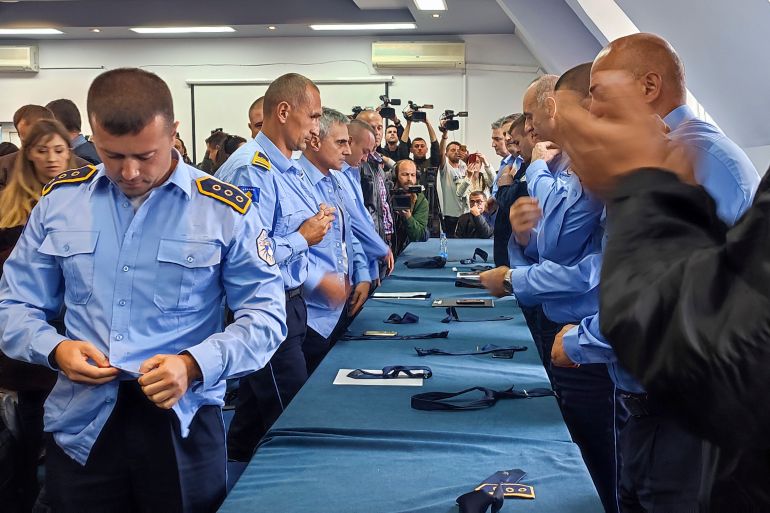 Serb police officers took off their uniforms in the town of Zvecan, Kosovo.
