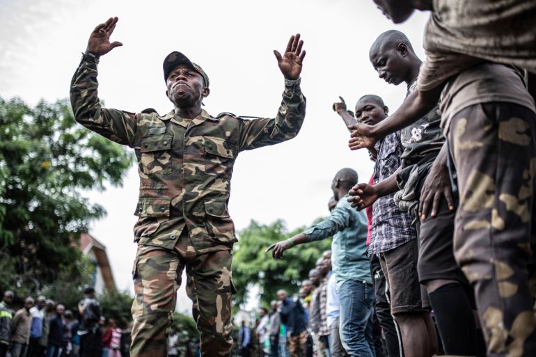 Democratic Republic of the Congo youth receive military training from a service member.