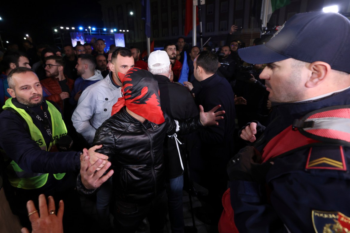 A protester having his head wrapped with an Albanian flag.