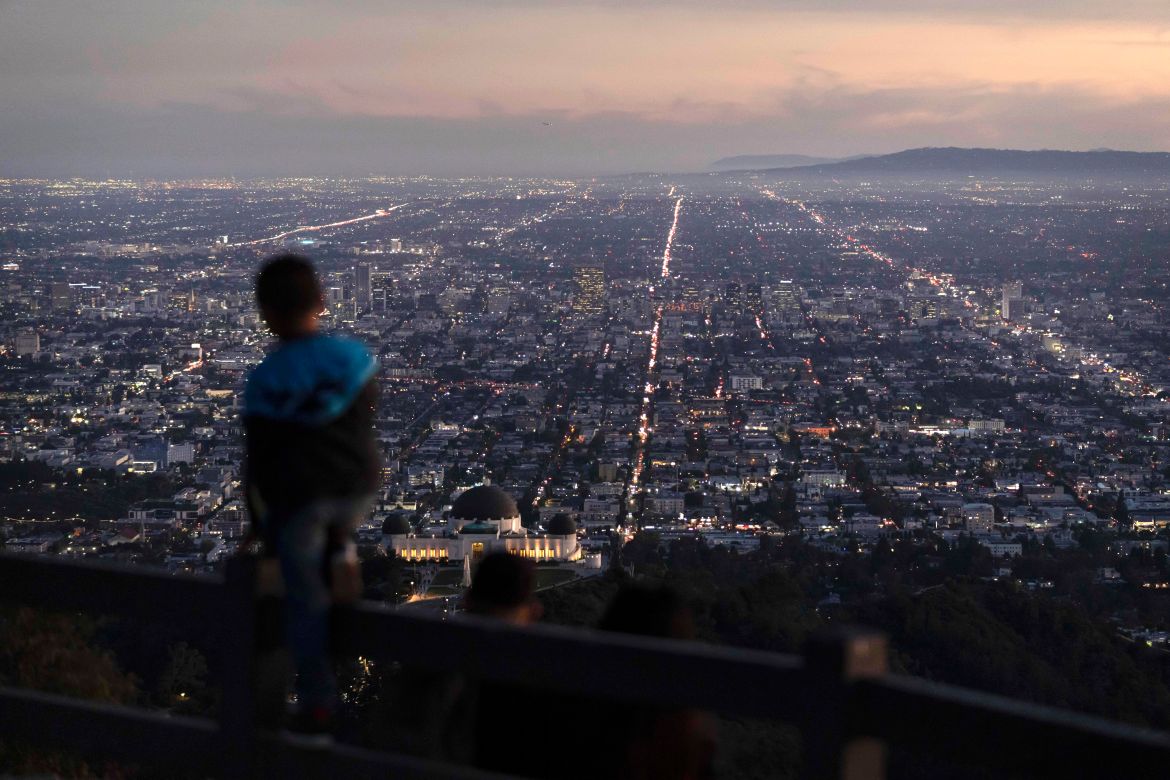 A boy takes in the view of the Los Angeles skyline from the Griffith Park Observatory Trails Peak in Los Angeles