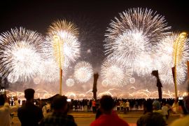 Fans watch a fireworks-filled sky after the World Cup inauguration match between Qatar and Ecuador at the Corniche sea promenade in Doha, Qatar.